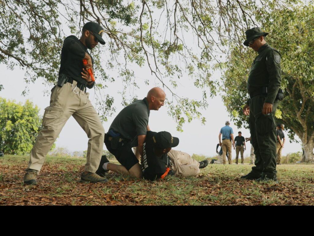 An FBI special agent demonstrates how to properly lift a suspect during a defensive tactics training for Transnational Organized Crime-Western Hemisphere (or TOC-West) vetted team partners held in Barbados in May 2024, As PART of A DOD-FBI Program that equips international partners to crush Cartel Violence. (U.S. Army photo by 1st Sgt. Emily Anderson)