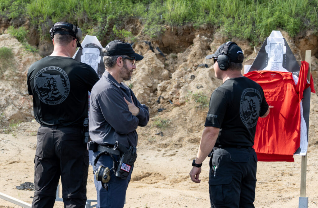 Rick Hogg with FHP students shooting a red tshirt