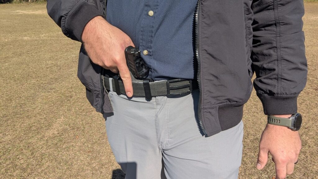 Man drawing from appendix carry with jacket partially swept.