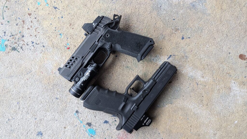 Overhead view of a Glock 17 and a Staccato HD pistol, both customized with optics and lights, on concrete.