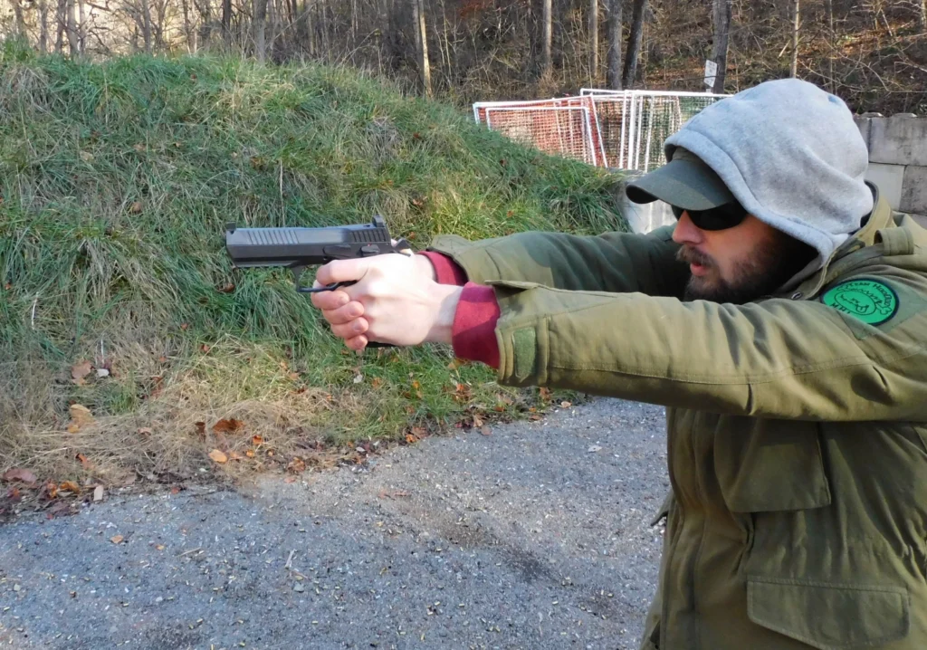 Man firing an IWI Jericho 941 pistol