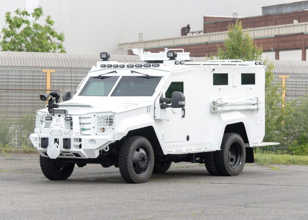White Lenco BearCat armored vehicle parked outside.