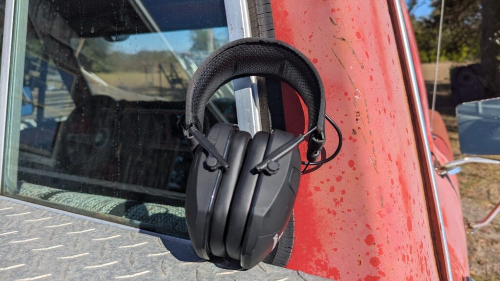 Safariland ear protection, folded, resting on the side of a red truck.