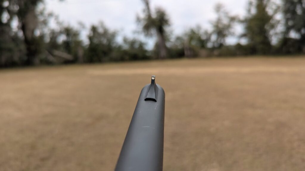 View down a barrel showing the fixed bead front sight