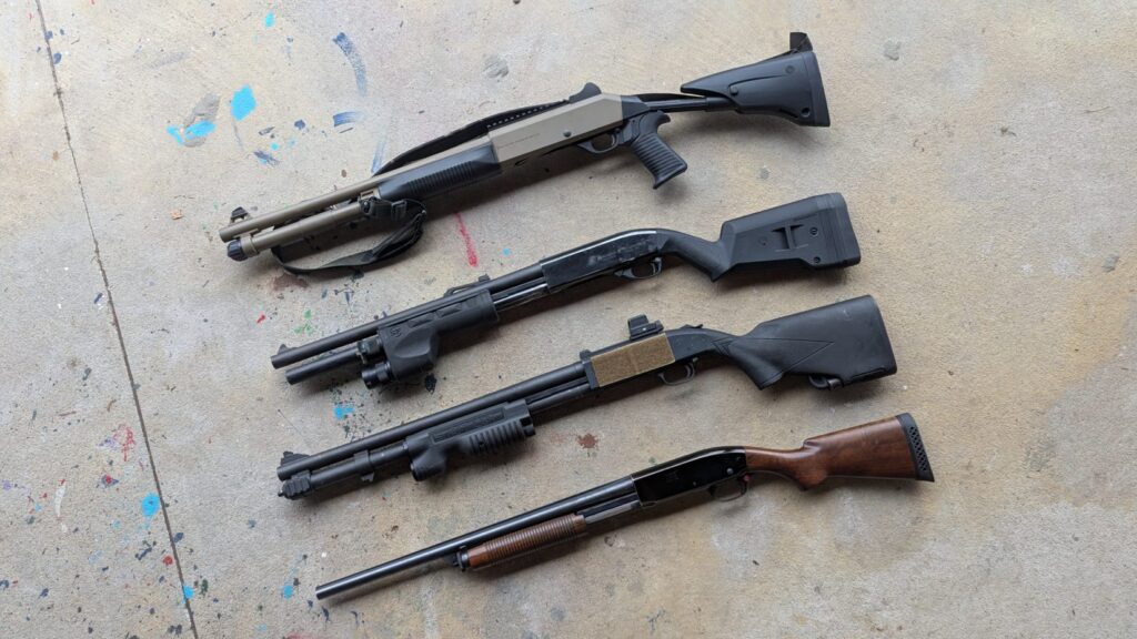Vareity of pump action and semi auto shotguns on concrete