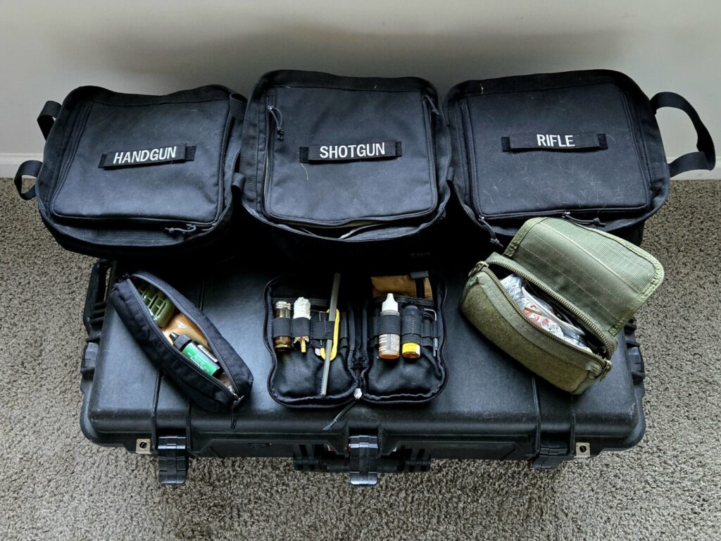 Three bags on top of a pelican case with cleaning supplies