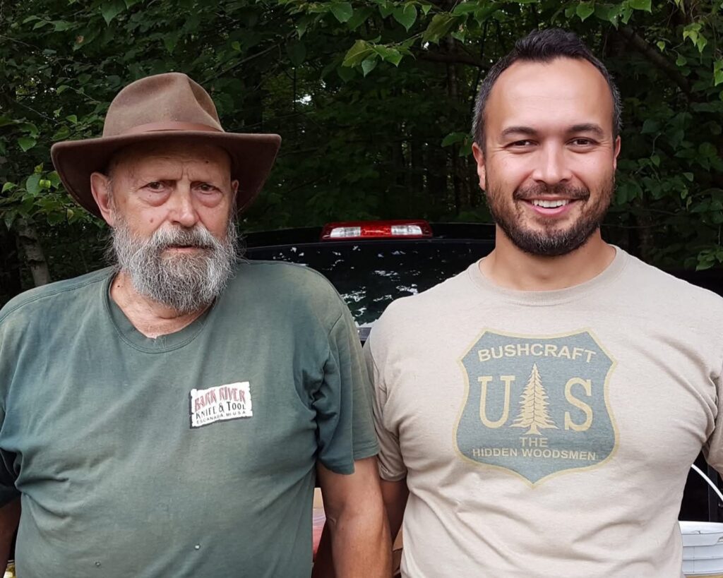 Two men standing at the tailgate of a pickup truck