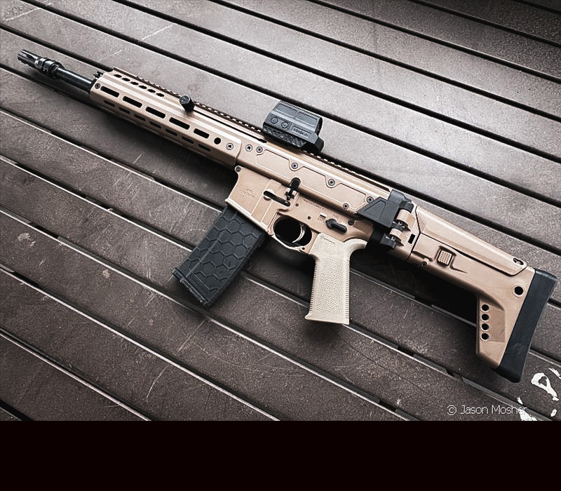 A light brown rifle laying on a metal table. 
