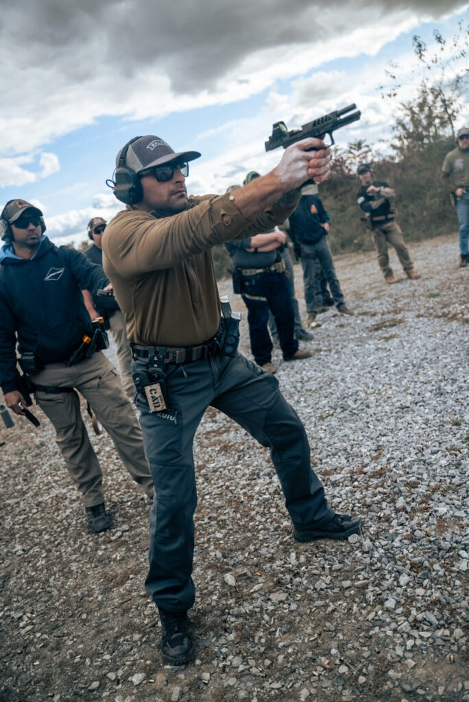 Paul Costa shooting a gun and leading a training class