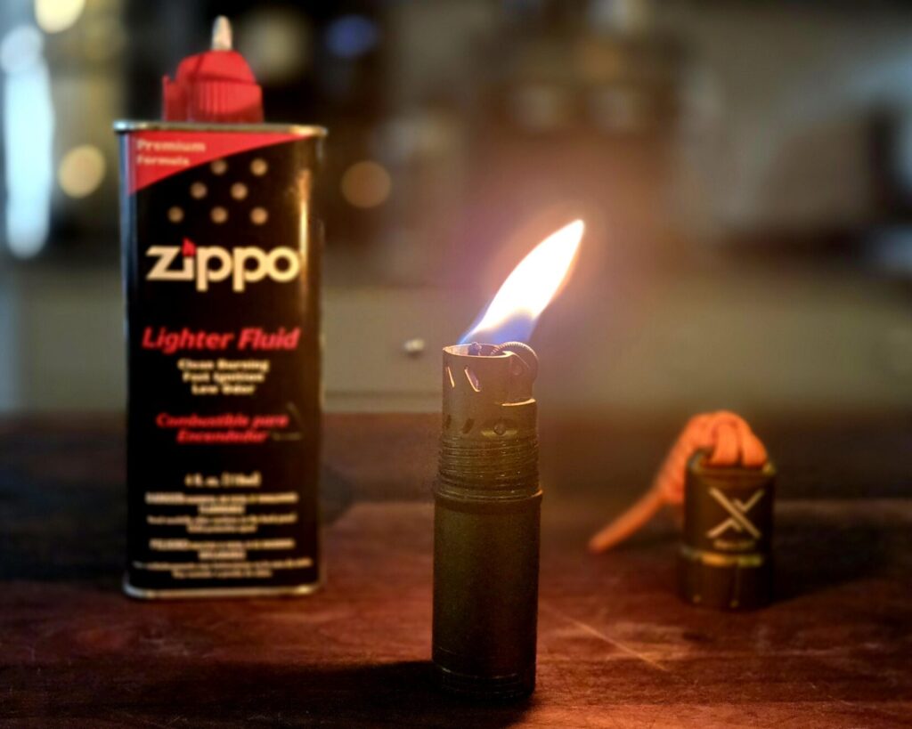 A lighter and lighter fluid on top of a cutting board.