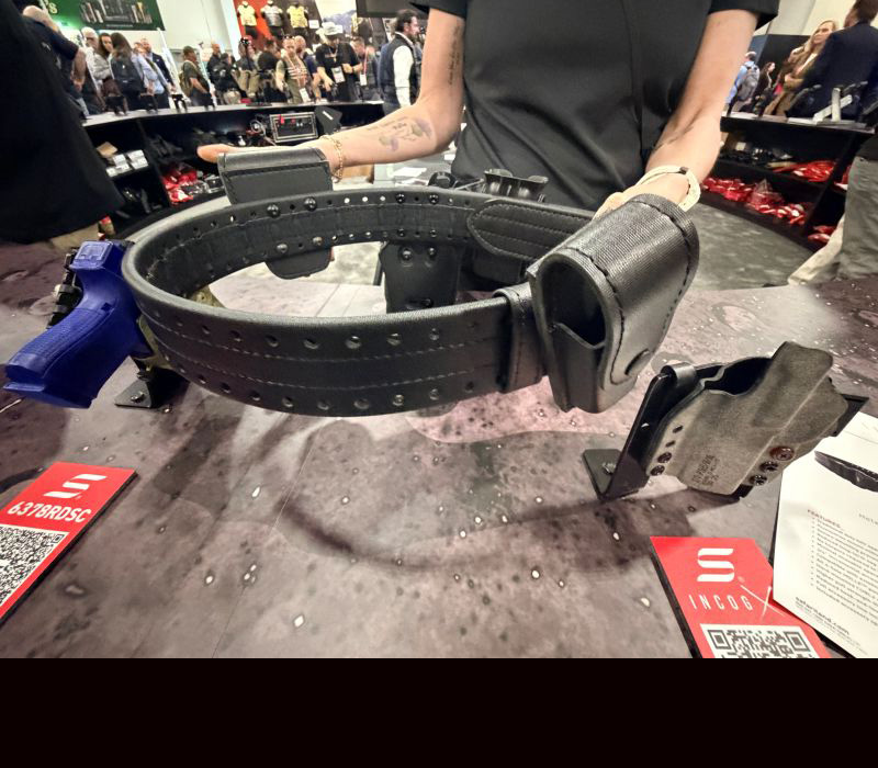 A person holding out the HOLLE duty belt for the camera during a product show. 