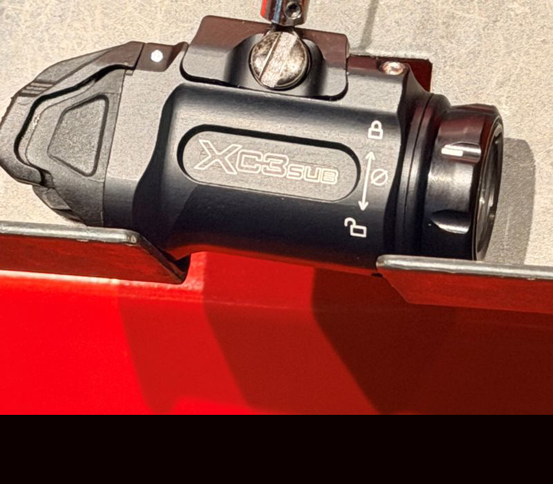 A black light on a red display stand, showing a view from the side.