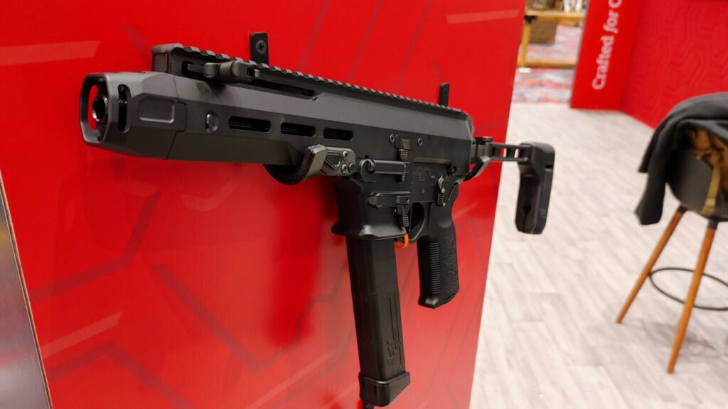 A compact black Nemo Mongoose 10mm pistol-caliber carbine with a side-folding brace.