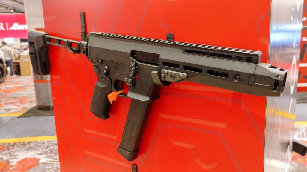 A compact black Nemo Mongoose 10mm pistol-caliber carbine with a side-folding brace.