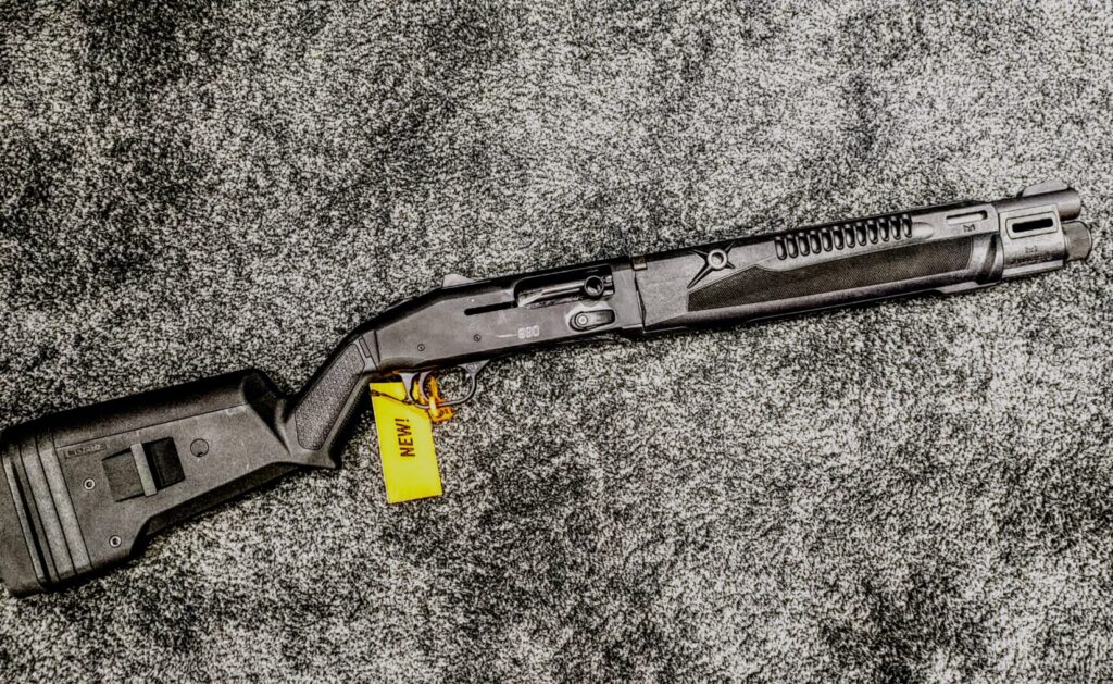 A top-down view of a Mossberg 940 Pro Tactical semi-automatic shotgun