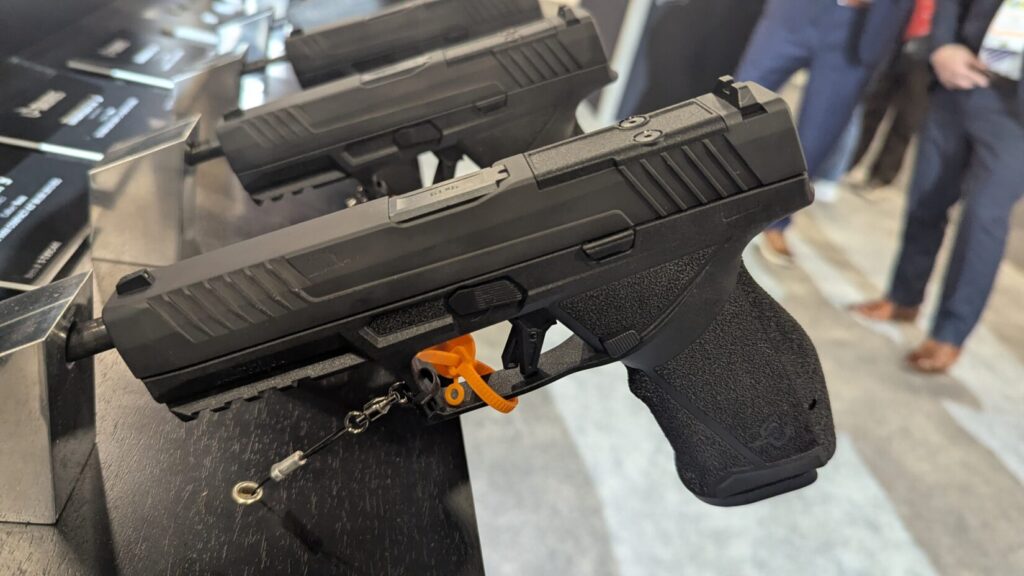 A display of modern TX9 striker-fired pistols, including a model with aggressive slide serrations and an optics-ready mounting plate.