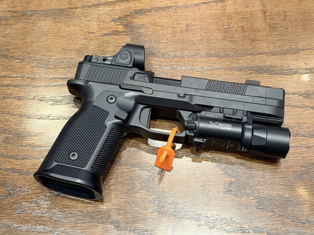 A Waltz 9, outfitted with an SRO red dot and an X300 weapon light.
