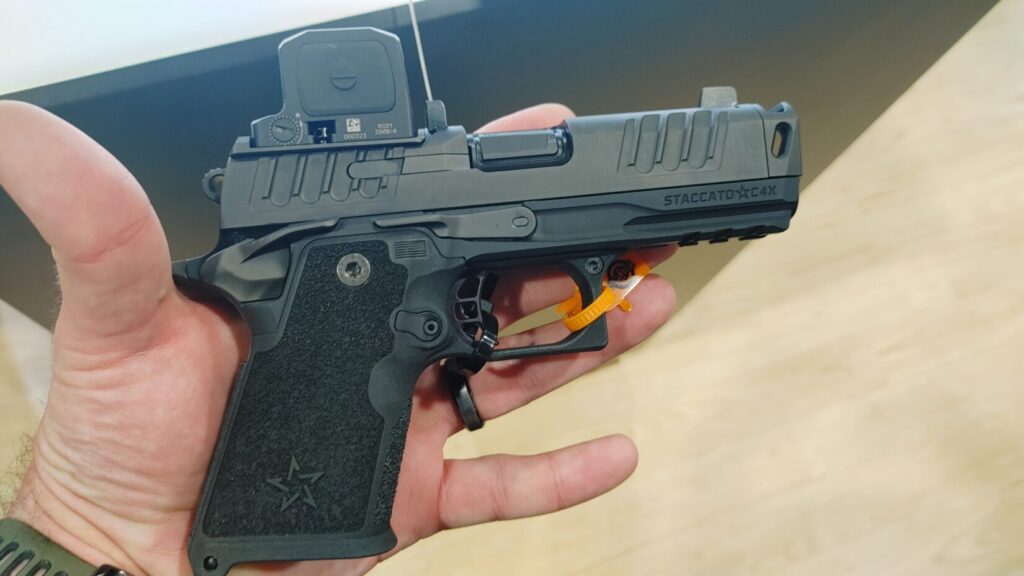 The Staccato C4X, a compact 2011-style pistol featuring an enclosed emitter red dot sight and a compensated barrel.