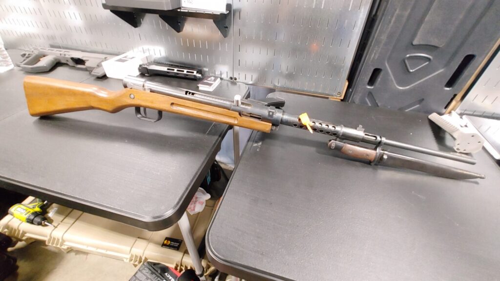 Full length of the GearHead Gunsmith Tensei, a semi-auto PCC recreation of the Japanese Type 100 featuring a wood stock and bayonet. 