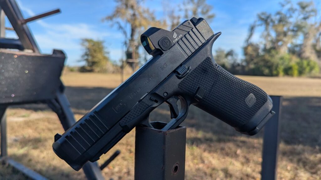 Close-up profile of a Glock 17 Gen 6 balanced on a metal post, highlighting the "Gen 6" slide marking.