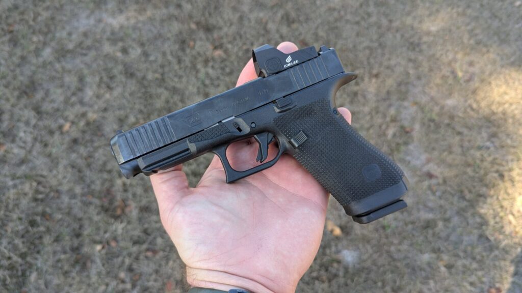 A person holding a Glock 17 Gen 6 in their palm to show the scale and grip size.