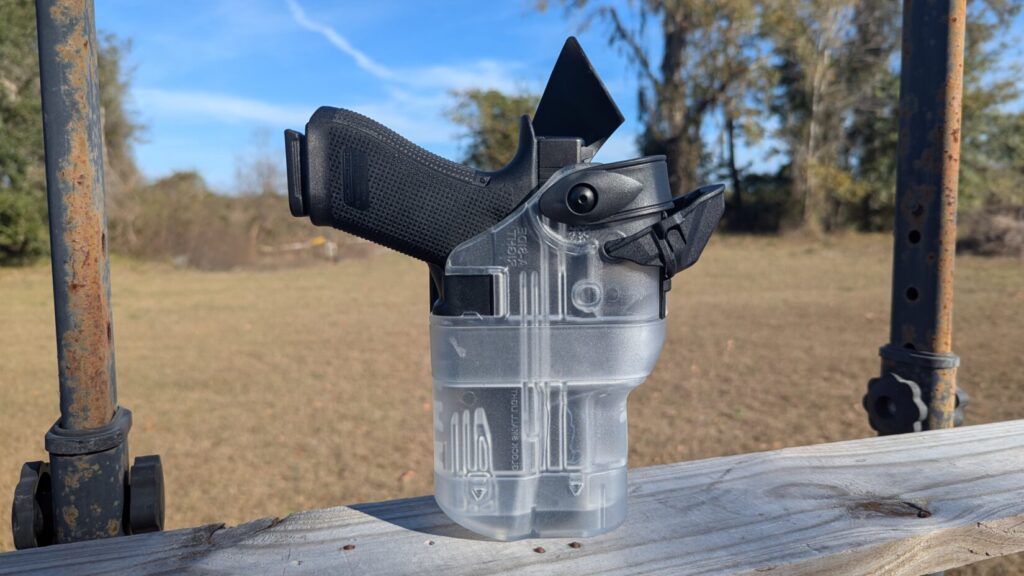 A Glock 17 Gen 6 secured in a translucent, clear plastic OWB (outside-the-waistband) holster.