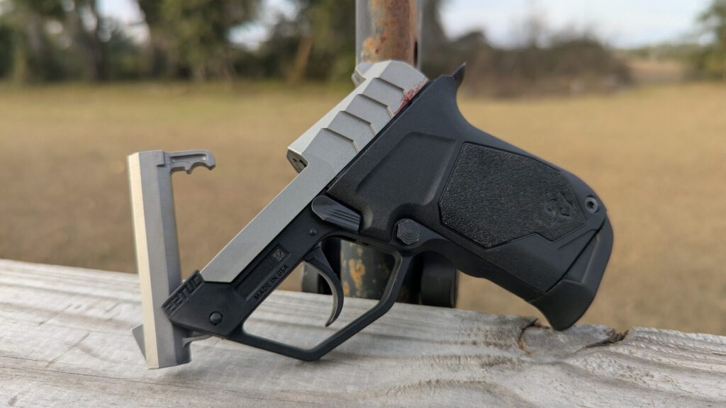 Left-side view of the Taurus 22TUC with its signature tip-up barrel fully deployed.