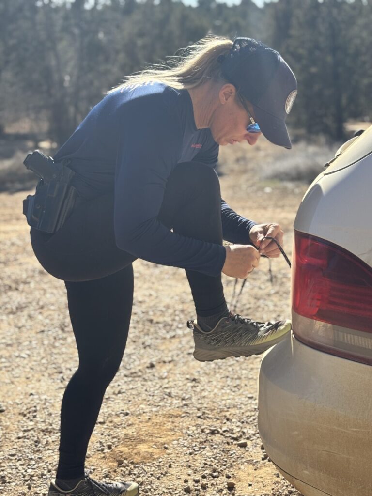 female athlete tying the laces of her running shoes