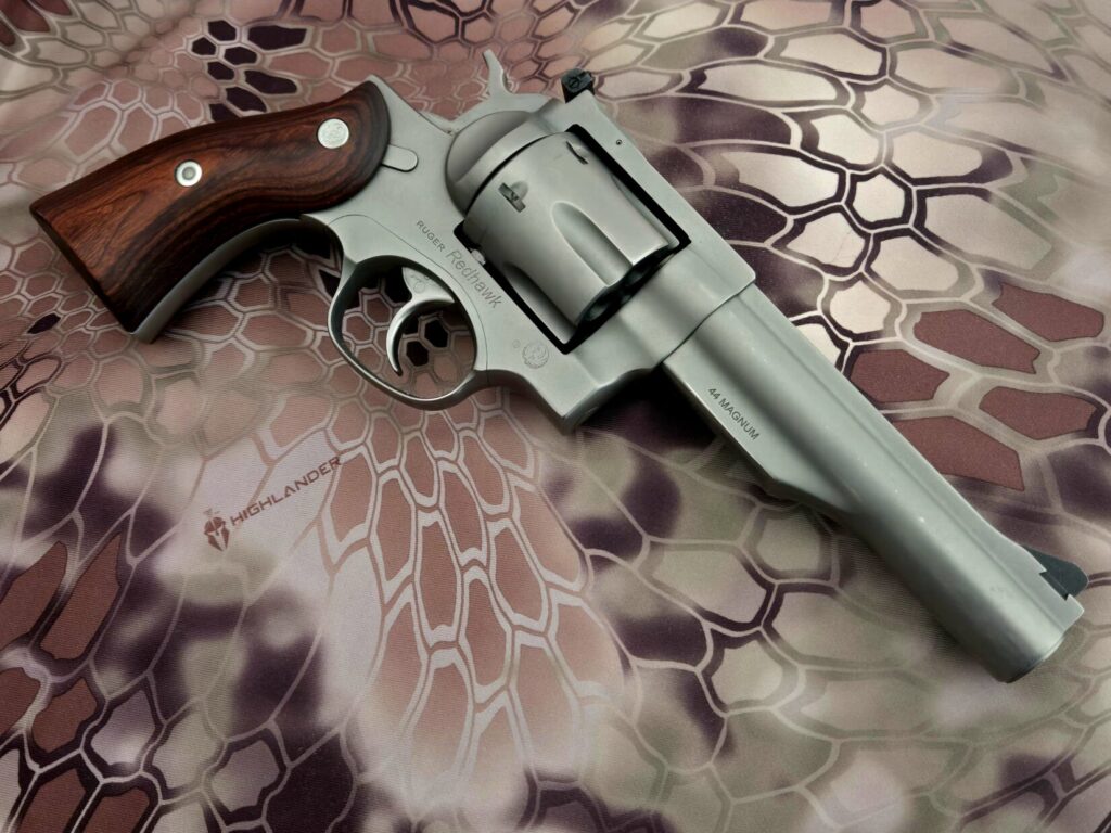 A revolver against a camouflage backdrop