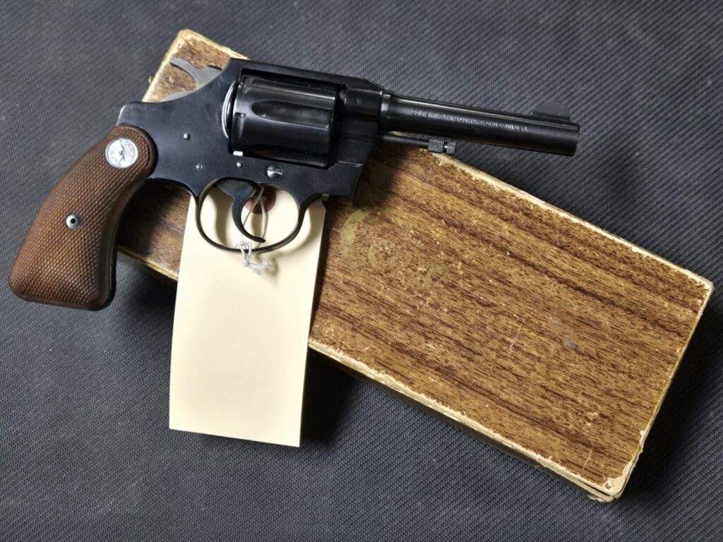 A Colt revolver with a factory box