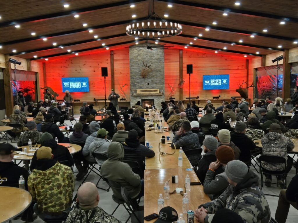 A crowd of people seated at tables in a large banquet hall