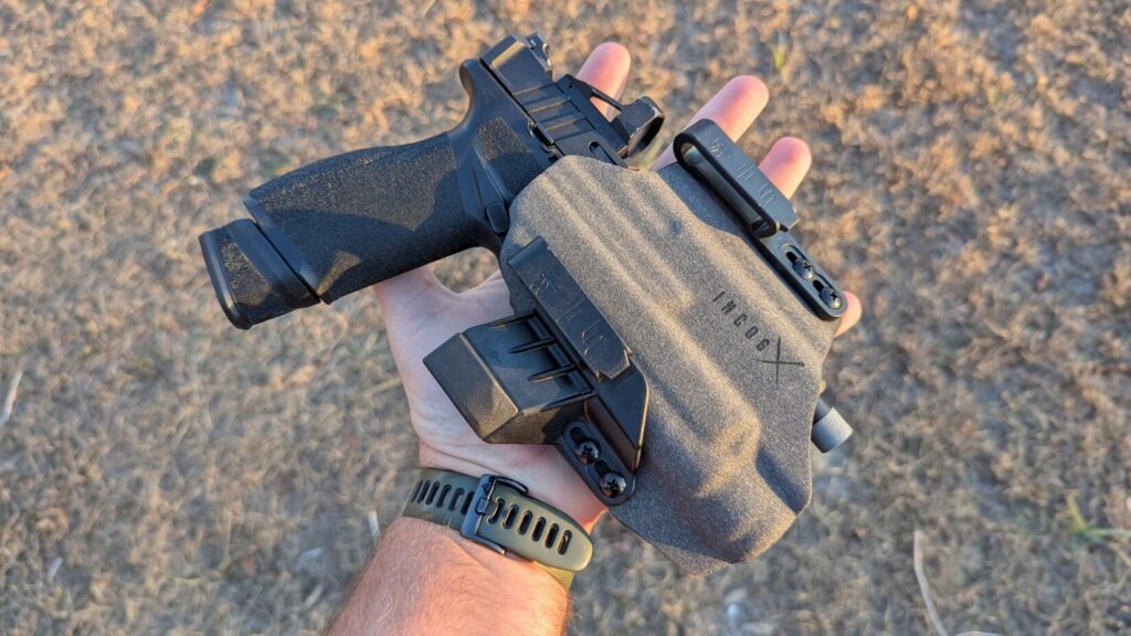 A flat side profile of the holstered Echelon held in a hand, showing the "IncogX" branding.