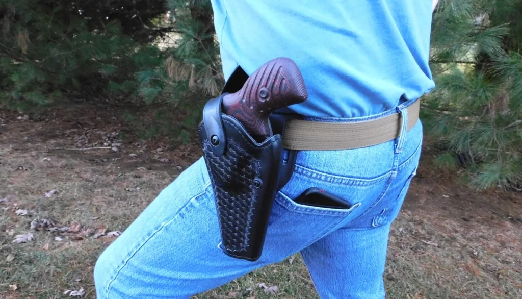Man wearing a holstered revolver on his hip
