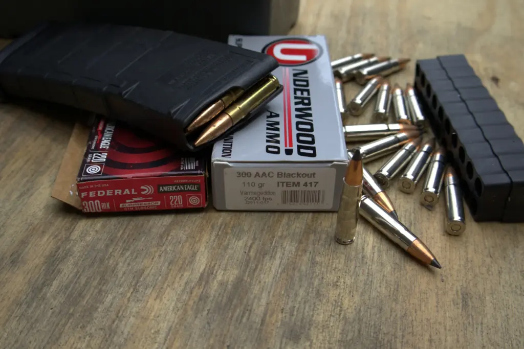 Boxes of .300 Blackout ammunition surrounded by loose rounds and rifle magazines