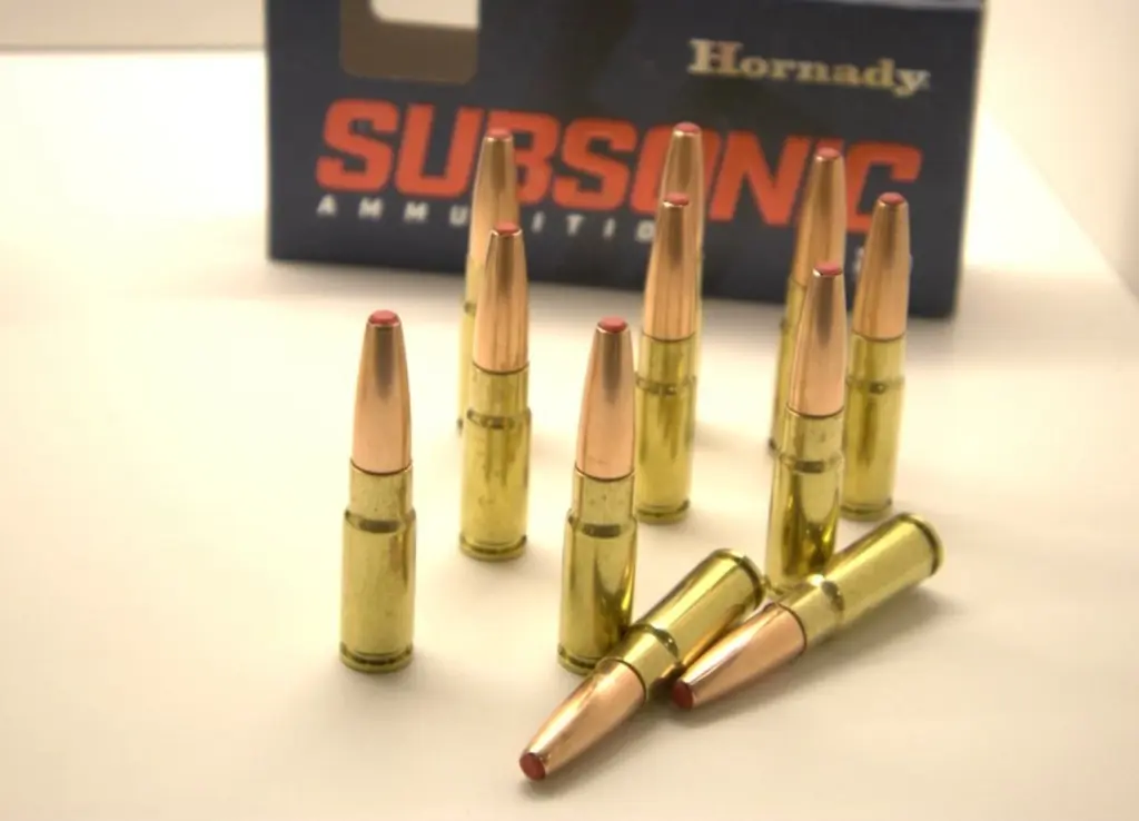 .338 ARC subsonic ammo cartridges standing before an ammo box