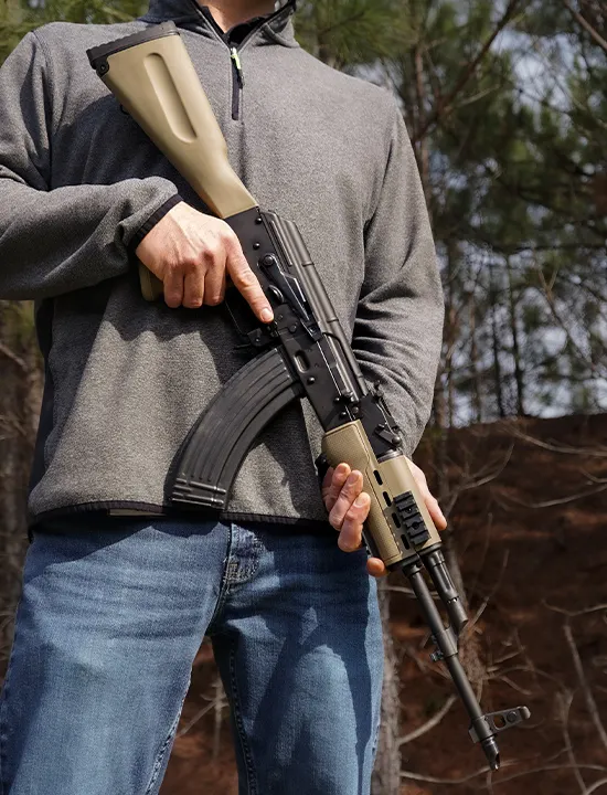 Man holding an AK47 Rifle