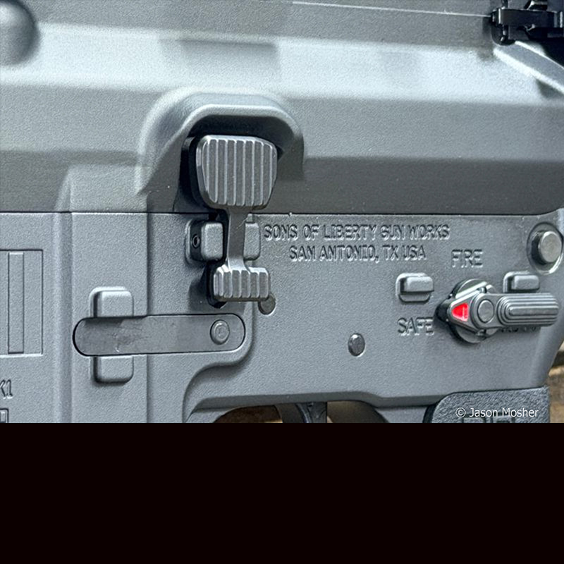 The side of the MK1 rifle, showing the oversized bolt release. 