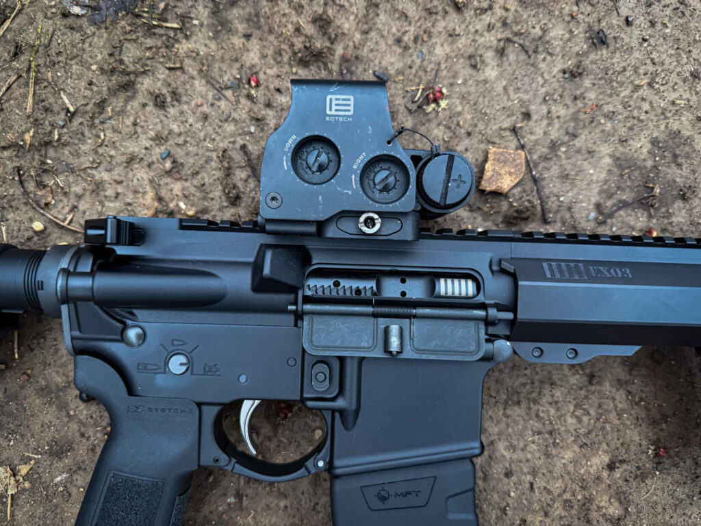 Black AR-15 rifle with a black red dot optic