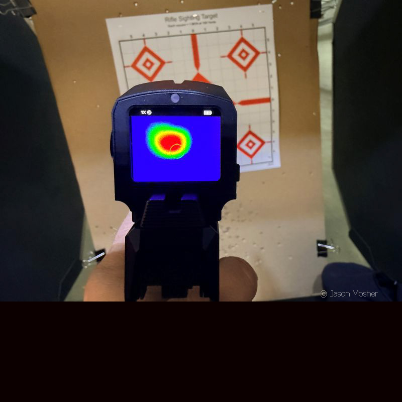 A view of the screen on the FML19 thermal optic, showing a round spot over the target with red in the middle and yellow around it. 