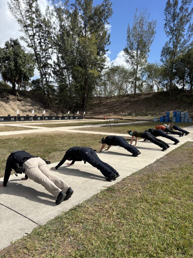 female officers doing pushups at outdoor range in Miami-Dade