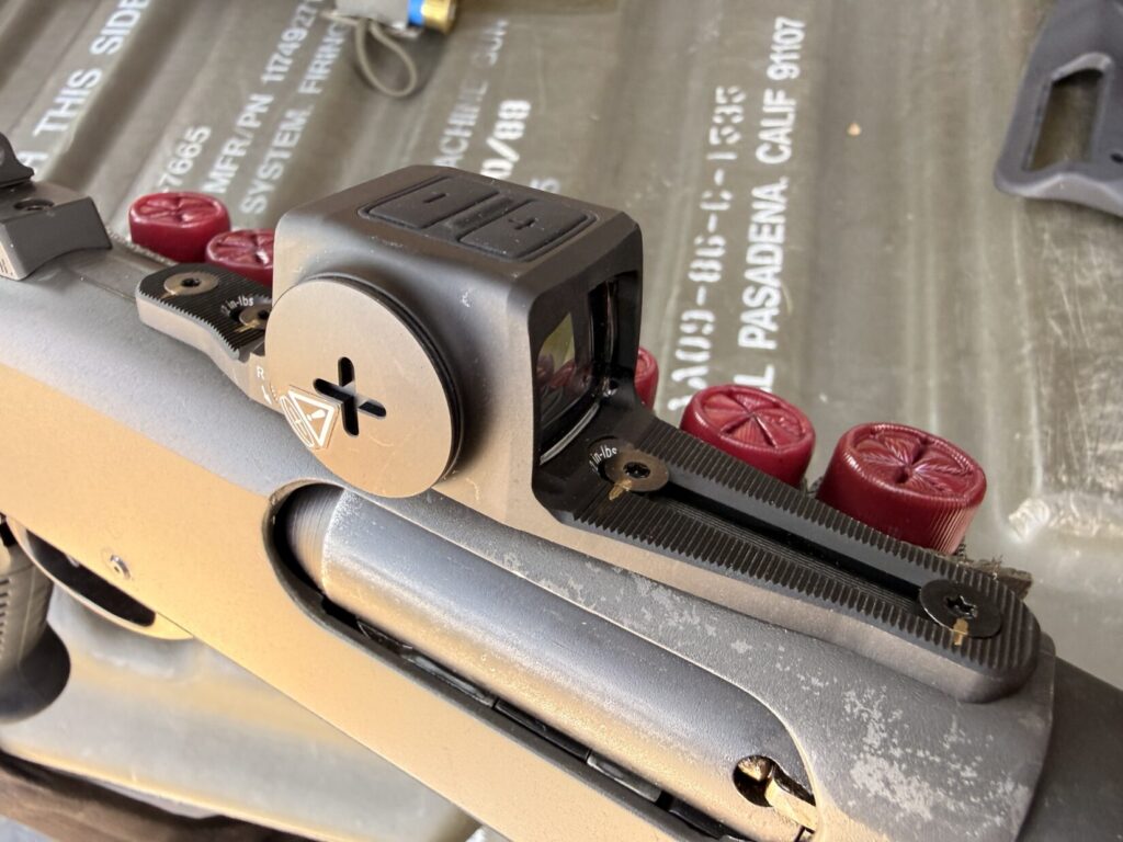 Close up view of a Vortex Viper enclosed shotgun red dot optic.