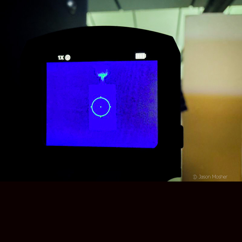 An view of the back of the FML19 thermal optic, showing a blue screen and the faint outline of a target on the screen. 