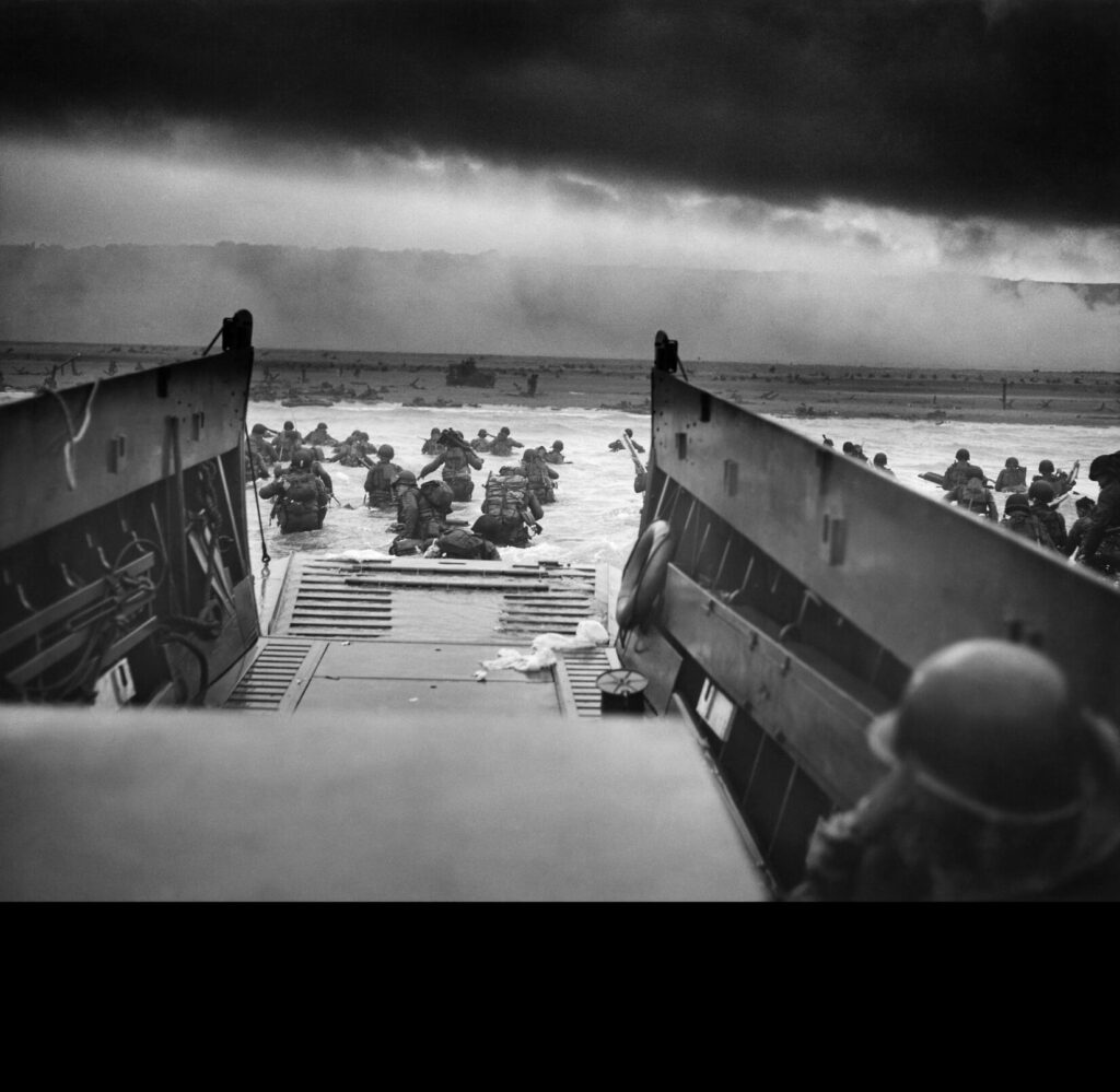 A LCVP (Landing Craft, Vehicle, Personnel) from the U.S. Coast Guard-manned USS Samuel Chase disembarks troops of Company A, 16th Infantry, 1st Infantry Division (the Big Red One) wading onto the Fox Green section of Omaha Beach (Calvados, Basse-Normandie, France) on the morning of June 6, 1944.