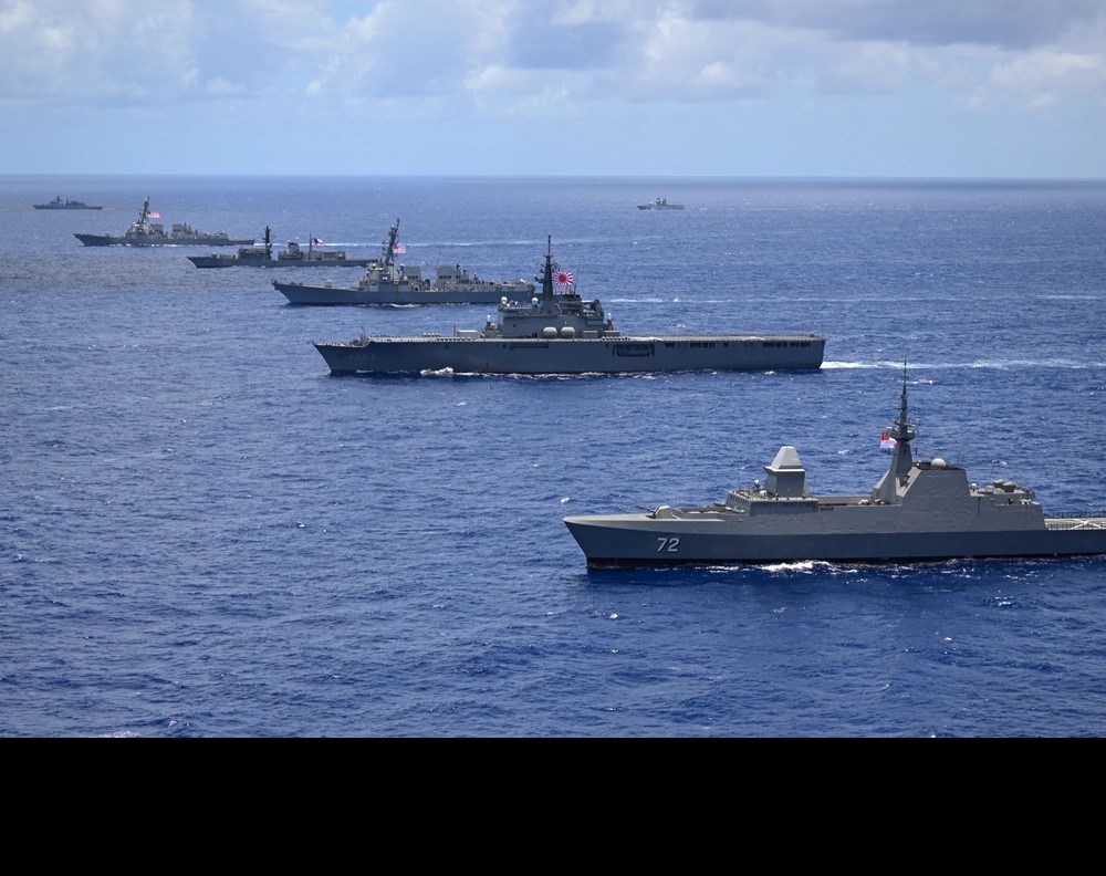 Multinational ships sail in formation during the Rim of the Pacific (RIMPAC) 2024 exercise. Held biennially, RIMPAC is the world’s largest international maritime warfare exercise. (U.S. Air Force photo by Master Sgt. Corban Lundborg)