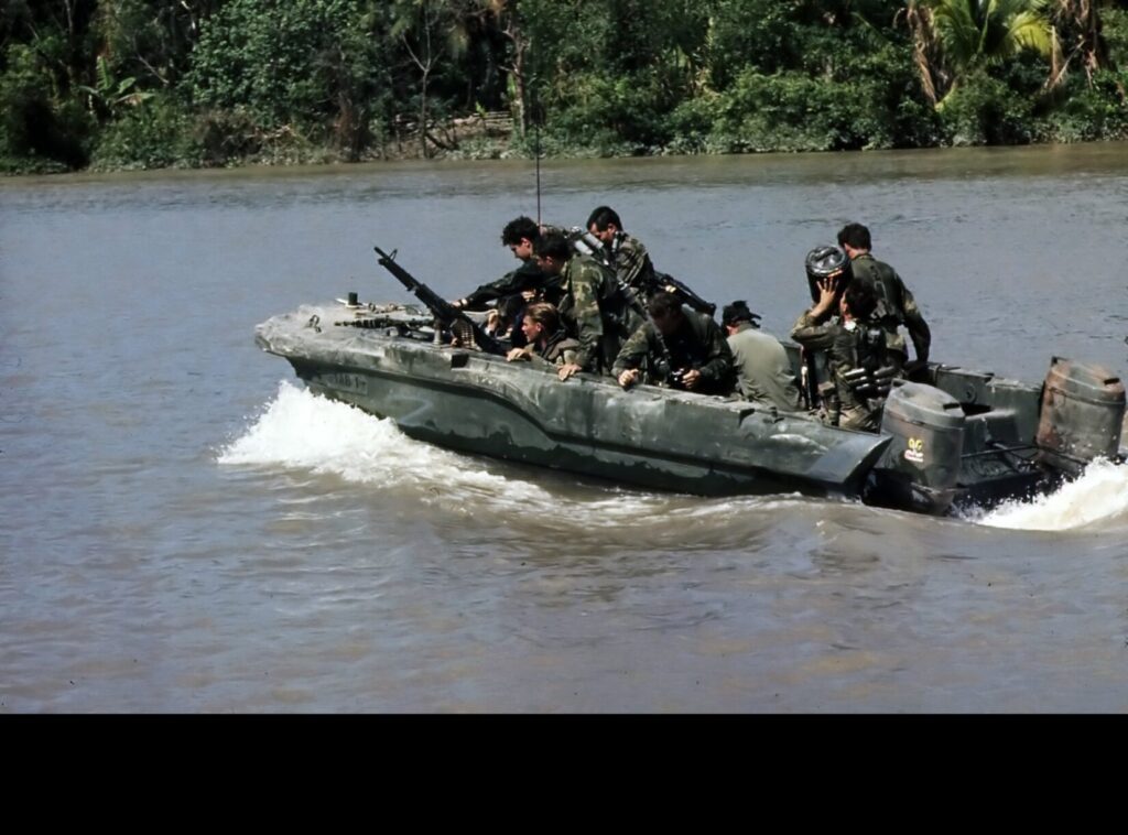 Members of SEAL Team One move down the Bassac River in a SEAL Team Assault Boat (STAB) during operations south of Saigon.