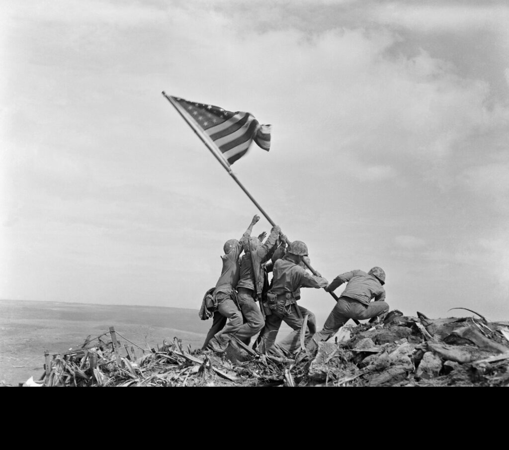 Raising the Flag on Iwo Jima, photographed by Joe Rosenthal in 1945. Public Domain. (National Archives)