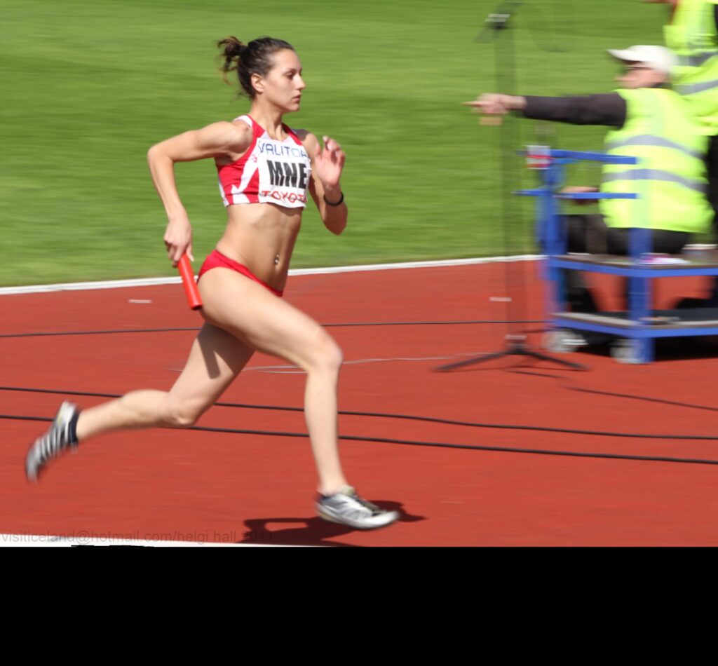 female runner in relay race
