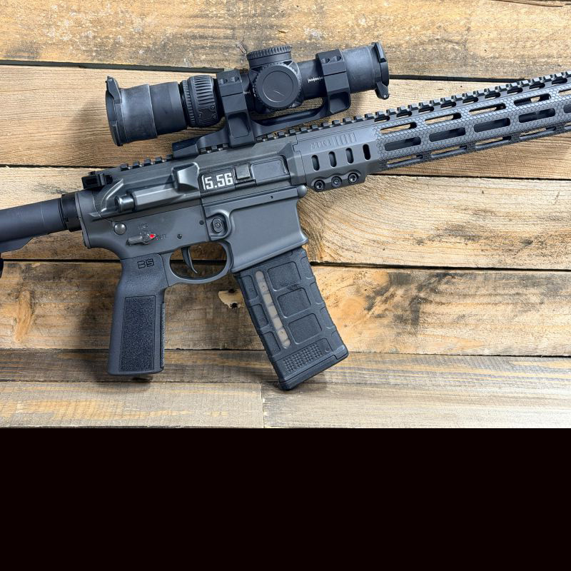 A side view of the MK1 rifle against a wooden wall. 
