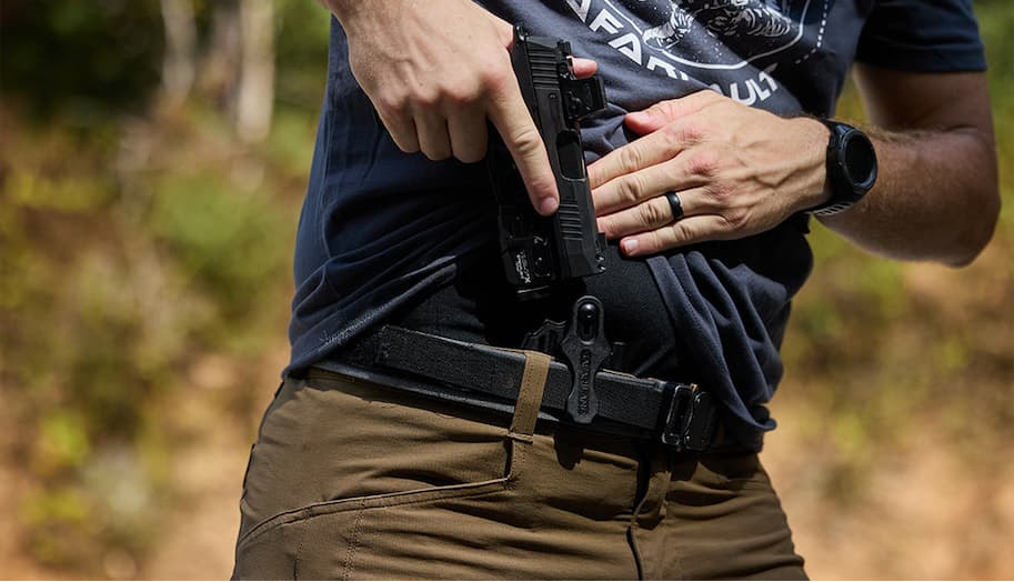 closeup image of holstering a Sig P365 with optic and weaponlight into the Safariland Schema IWB holster