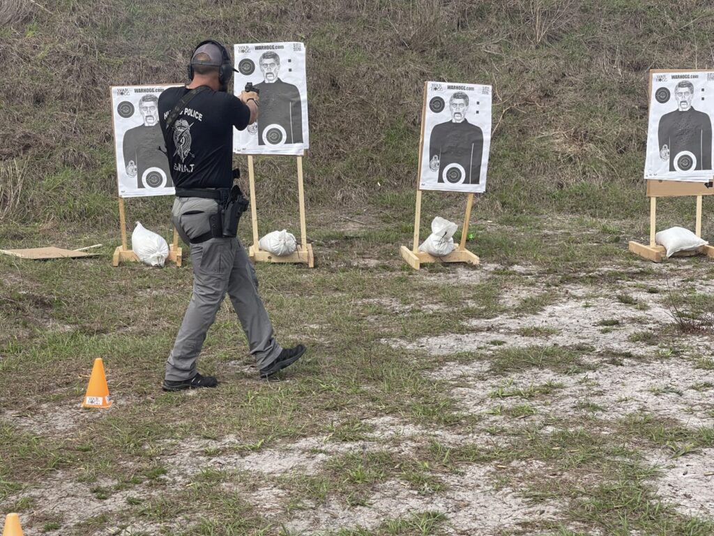 pictured is a police officer using his duty pistol during the War HOGG "L" CQB drill